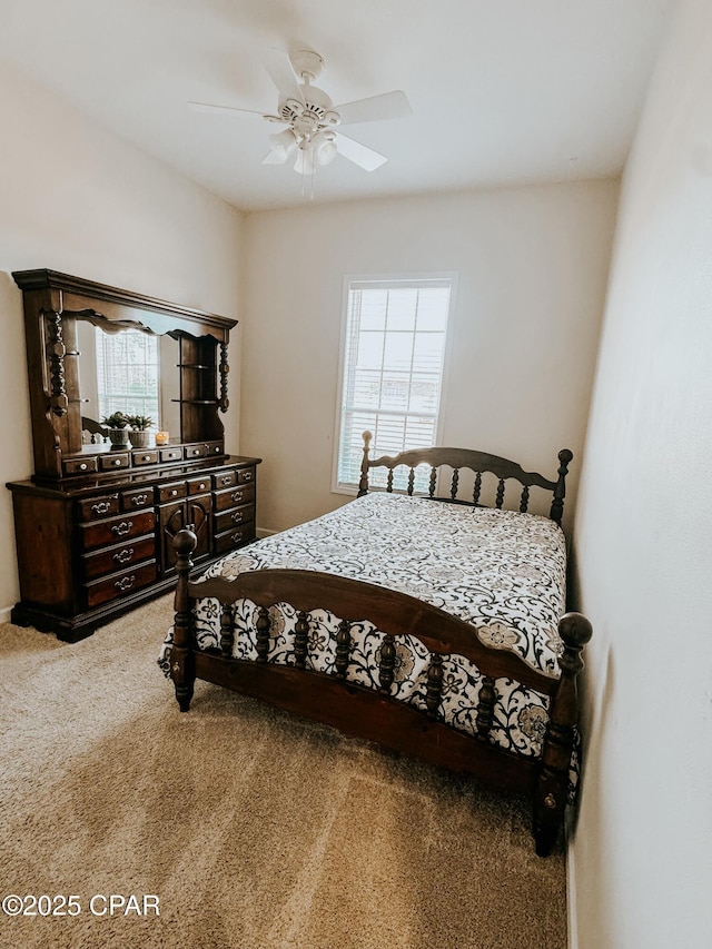 bedroom featuring ceiling fan, carpet flooring, and multiple windows