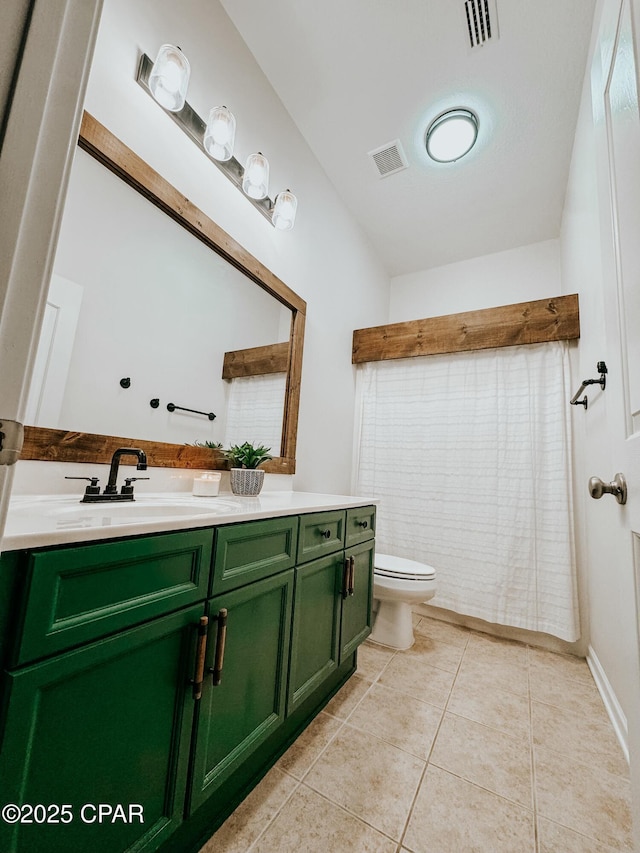 bathroom with vanity, tile patterned floors, and toilet