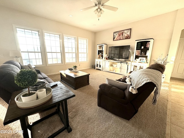 carpeted living room with ceiling fan