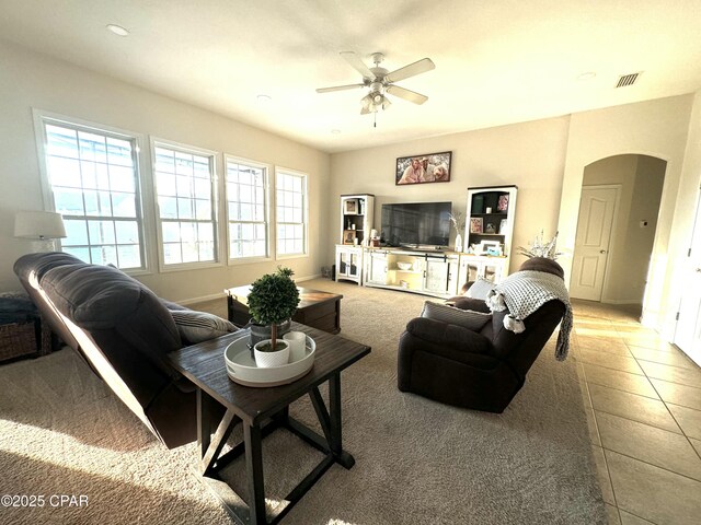 tiled living room featuring ceiling fan