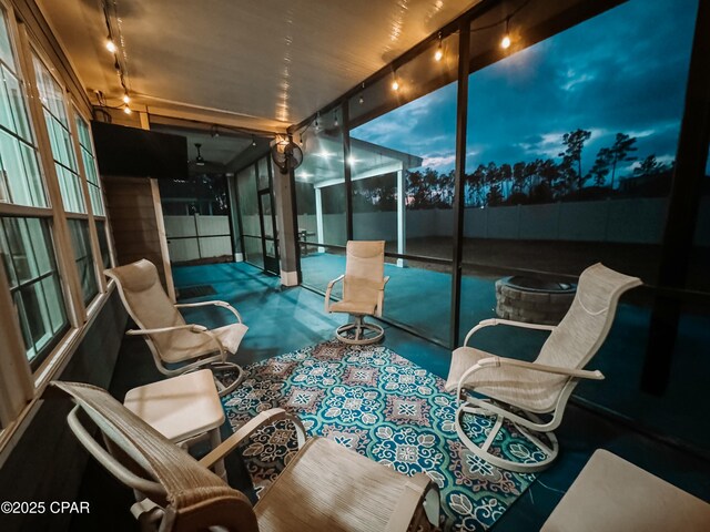 sunroom with a swimming pool and track lighting