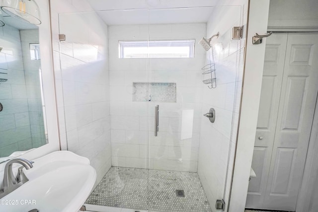 bathroom with sink and an enclosed shower