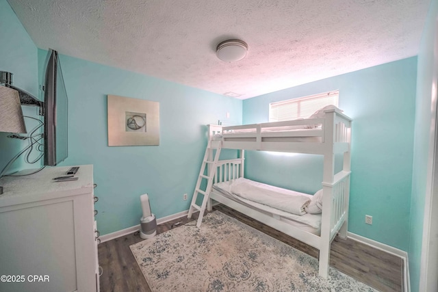 bedroom with a textured ceiling and hardwood / wood-style flooring