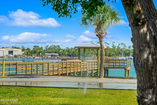 view of dock with a gazebo and a water view