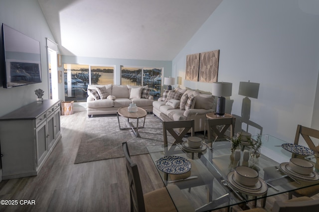living area with high vaulted ceiling and wood finished floors