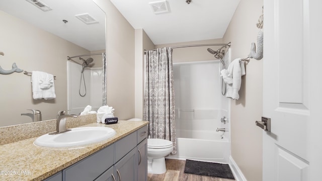 full bathroom featuring toilet, vanity, wood-type flooring, and shower / tub combo with curtain