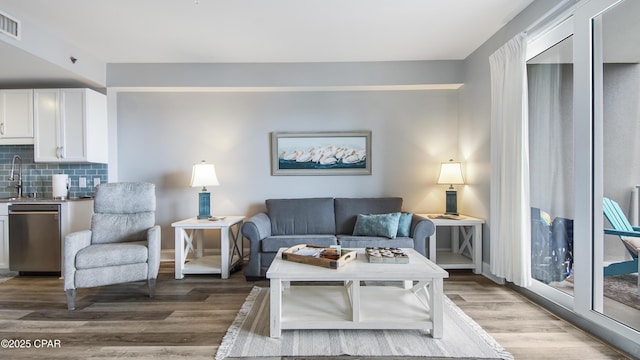 living room featuring sink and hardwood / wood-style floors