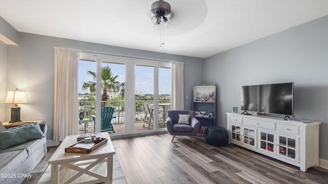 living room with dark wood-type flooring and ceiling fan