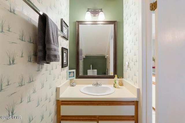 bathroom featuring wallpapered walls and vanity