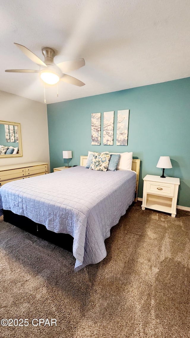 carpeted bedroom with ceiling fan and baseboards