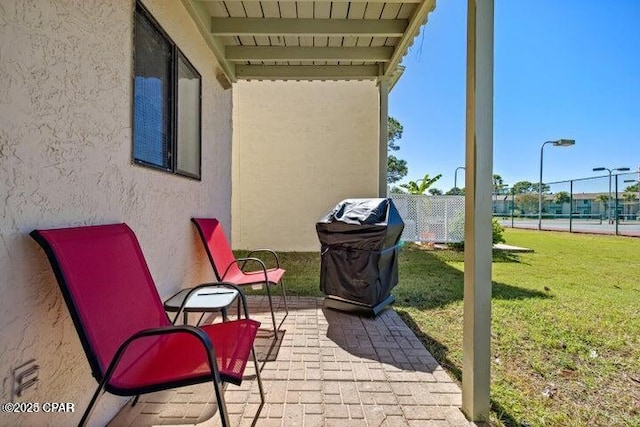 view of patio / terrace featuring a grill and fence