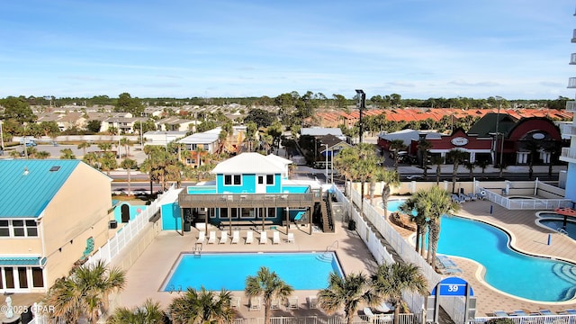 pool featuring a patio area, a fenced backyard, and a residential view