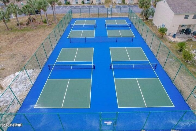 view of sport court with fence