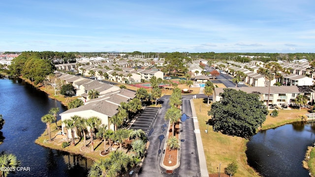 drone / aerial view with a residential view and a water view