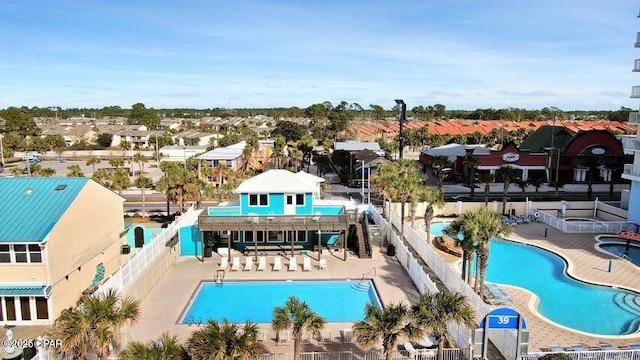 pool with a patio area, a fenced backyard, and a residential view