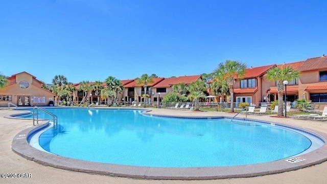 pool with a residential view and fence