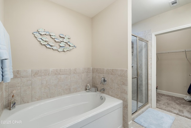 bathroom featuring separate shower and tub