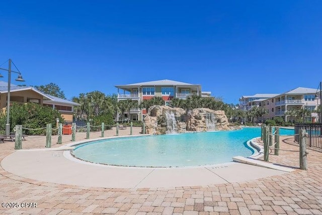 view of swimming pool with pool water feature