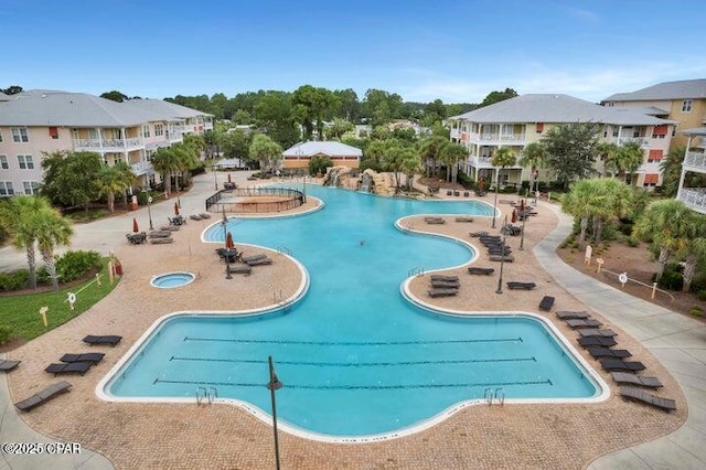 view of pool with a hot tub