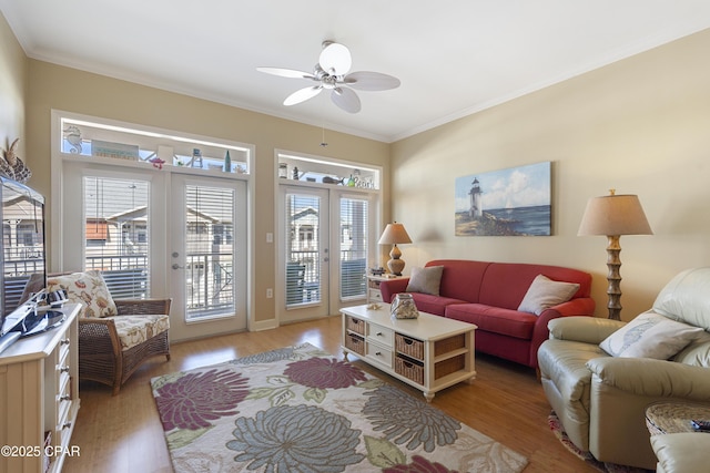 living room with ceiling fan, french doors, crown molding, and light hardwood / wood-style flooring