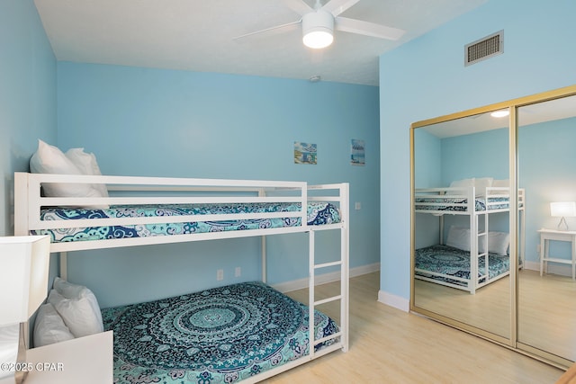 bedroom featuring ceiling fan, a closet, and wood-type flooring