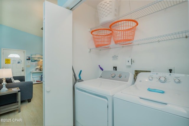 washroom featuring separate washer and dryer and light hardwood / wood-style flooring