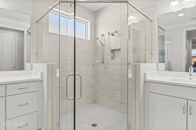 bathroom with a shower stall, visible vents, crown molding, and vanity