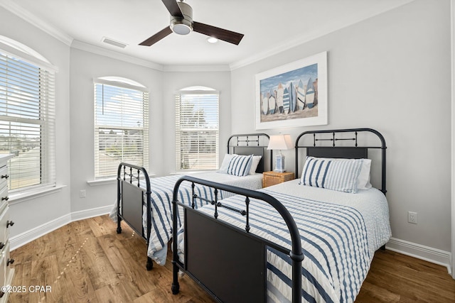 bedroom featuring crown molding, ceiling fan, and wood-type flooring