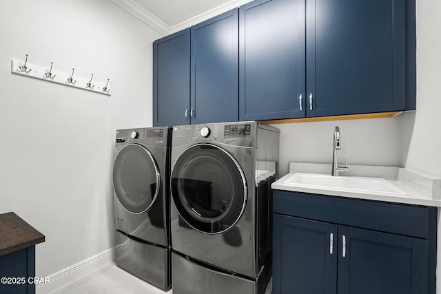 washroom featuring ornamental molding, a sink, independent washer and dryer, baseboards, and cabinet space