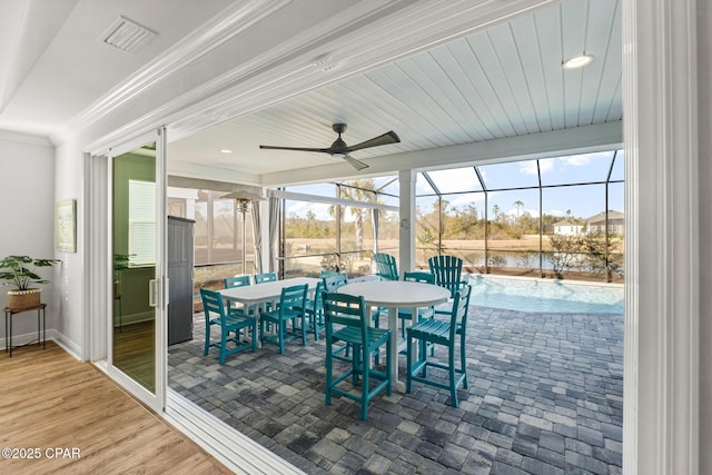 exterior space with glass enclosure, a swimming pool, visible vents, a ceiling fan, and outdoor dining space