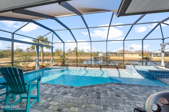view of pool featuring a patio area, glass enclosure, a pool with connected hot tub, and a water view