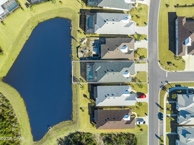 drone / aerial view with a residential view and a water view