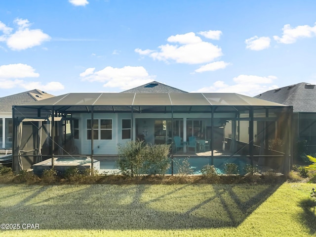 back of house with a lawn, a patio, and glass enclosure