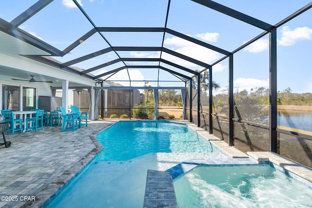 view of pool with a lanai, a pool with connected hot tub, a patio area, and a ceiling fan
