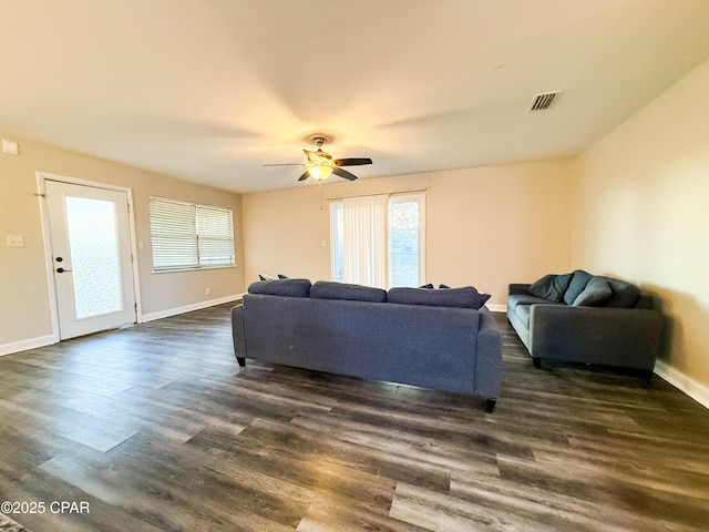 living room with ceiling fan, dark wood finished floors, visible vents, and baseboards