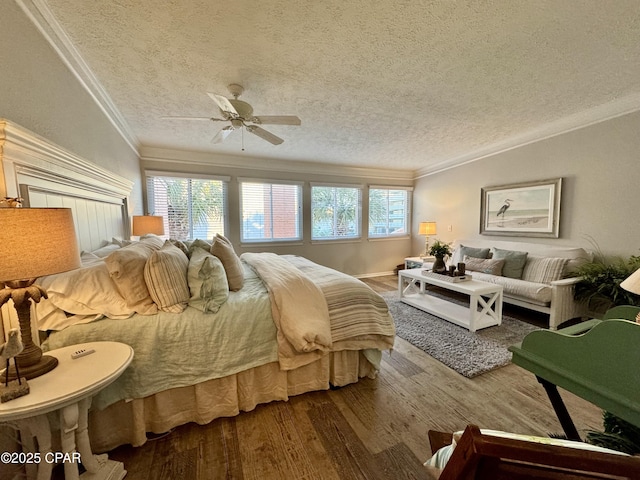 bedroom with crown molding, ceiling fan, a textured ceiling, and hardwood / wood-style flooring