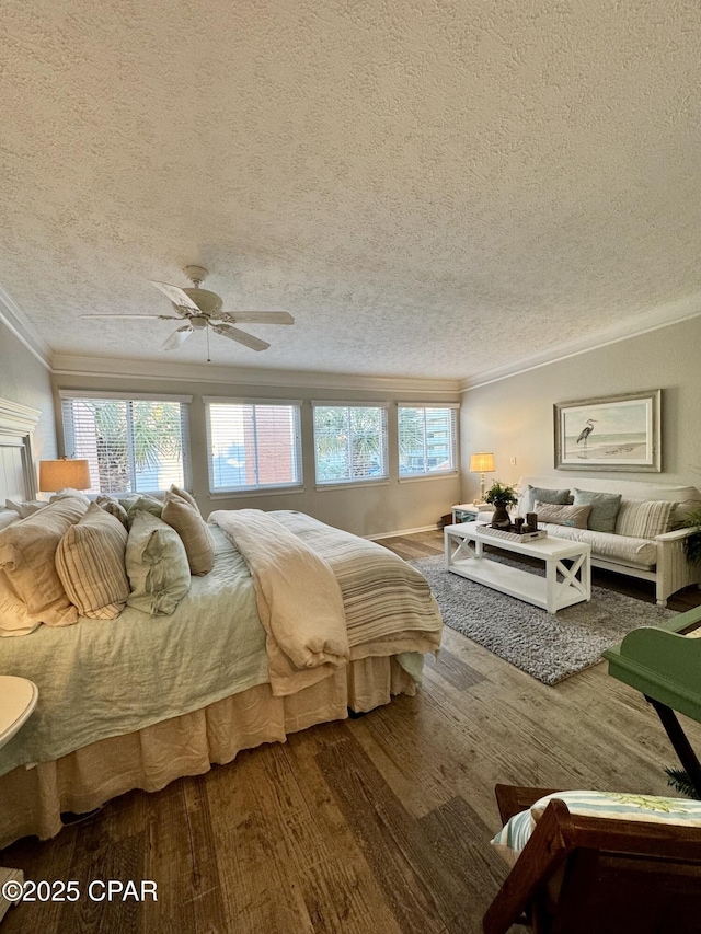 bedroom featuring ornamental molding, hardwood / wood-style floors, a textured ceiling, and ceiling fan