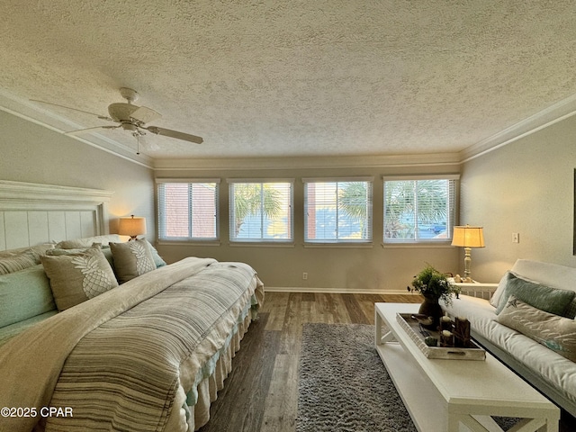 bedroom with a textured ceiling, ornamental molding, dark hardwood / wood-style floors, ceiling fan, and multiple windows