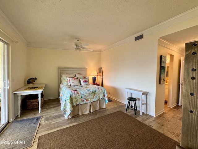 bedroom featuring crown molding, ceiling fan, hardwood / wood-style floors, and a textured ceiling