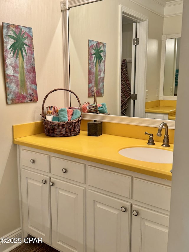 bathroom with ornamental molding and vanity