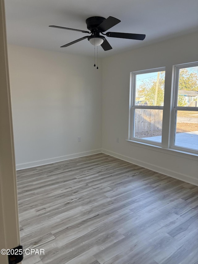 empty room featuring ceiling fan and light hardwood / wood-style flooring