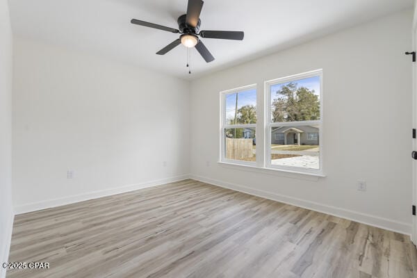 spare room featuring light hardwood / wood-style flooring and ceiling fan