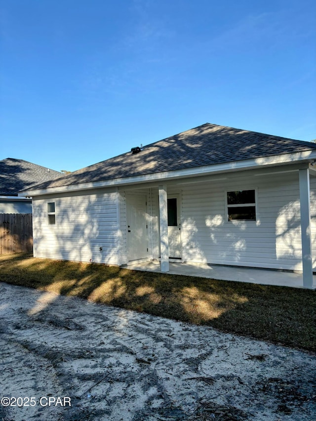 rear view of house featuring a yard and a patio area