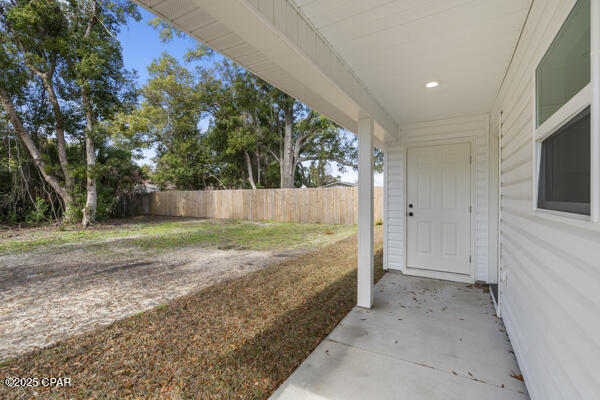 rear view of house with a patio area and a lawn