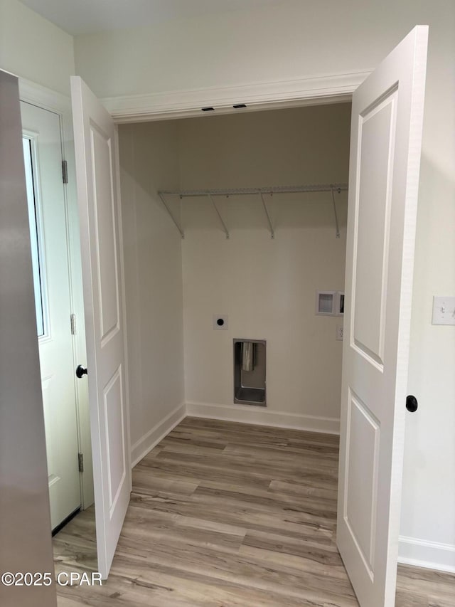 washroom featuring washer hookup, light hardwood / wood-style floors, and electric dryer hookup