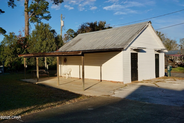 view of outbuilding with a yard and a carport