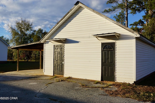 view of outbuilding with a carport