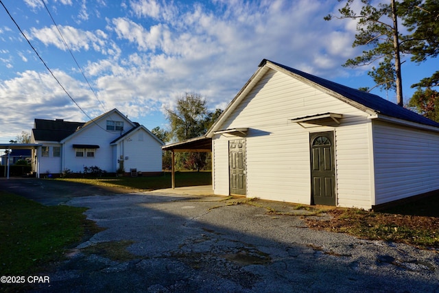 view of side of property featuring a carport