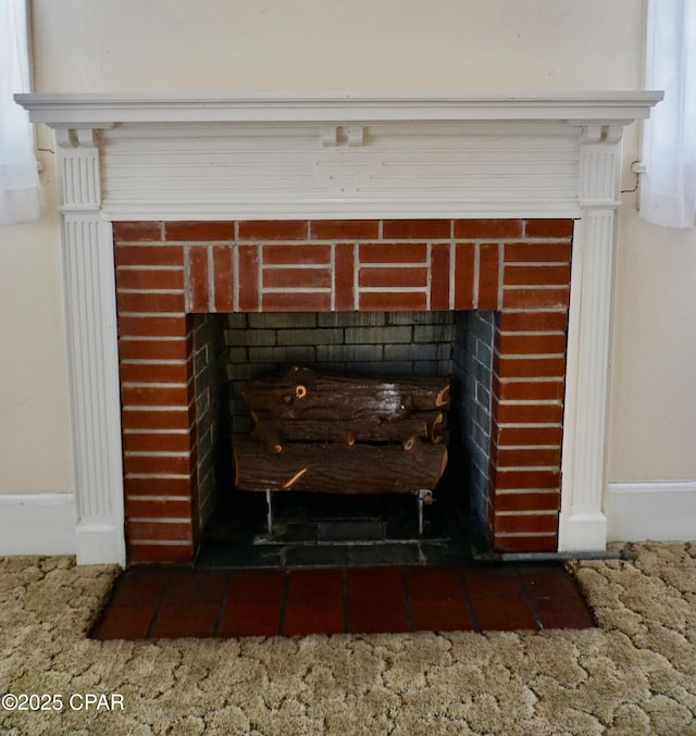 room details featuring a brick fireplace