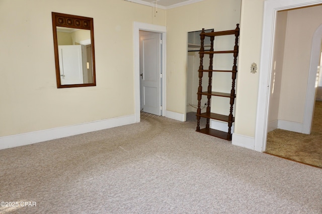 unfurnished bedroom with ornamental molding and carpet floors